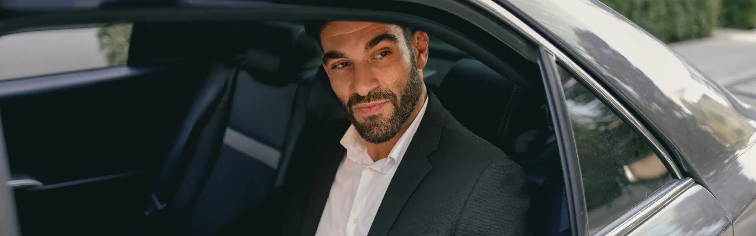 confidence businessman sitting car backseat working with documents use laptop scaled