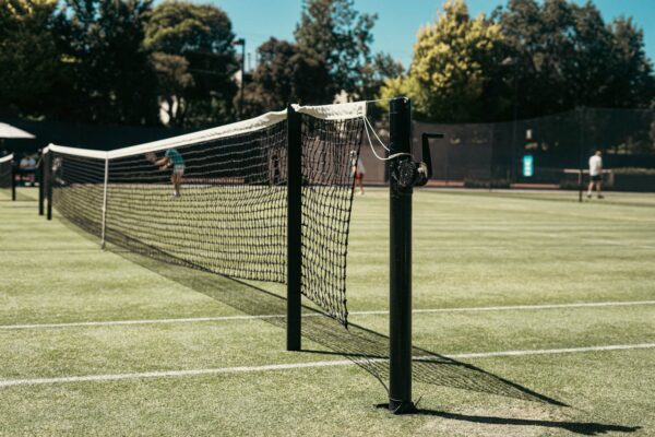 Homepage 27 A sunlit grass tennis court in summer, the spirit of the Championships