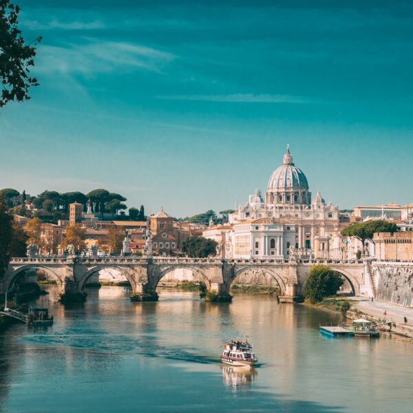 Rome, Italy. Papal Basilica Of St. Peter In The Vatican. Sightseeing Boat Floating Near Aelian Bridge. Touristic Boat